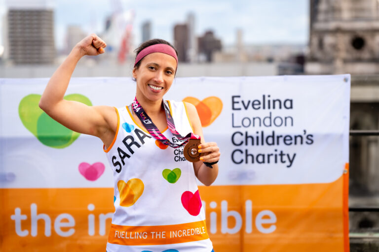 A supporter of Evelina smiles after running the London Marathon