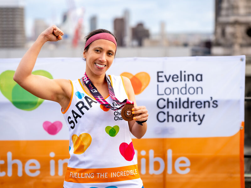 A supporter of Evelina smiles after running the London Marathon