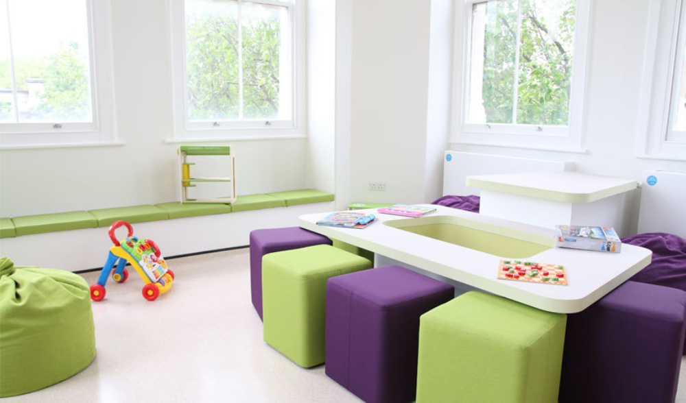 Snow leopard room at Evelina with soft purple and green stools, large windows and comfy looking benches.