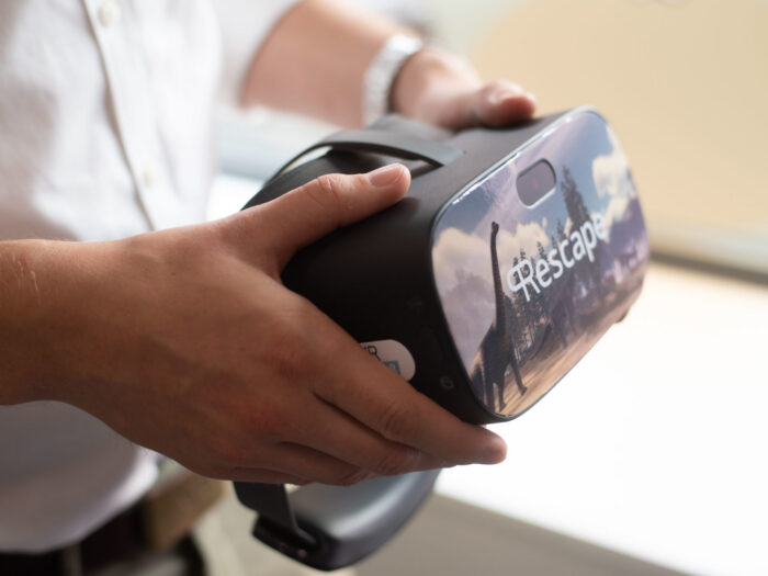 Hands holding VR headset