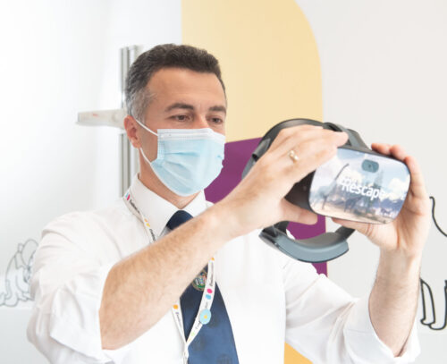 Male hospital workers holds VR headset