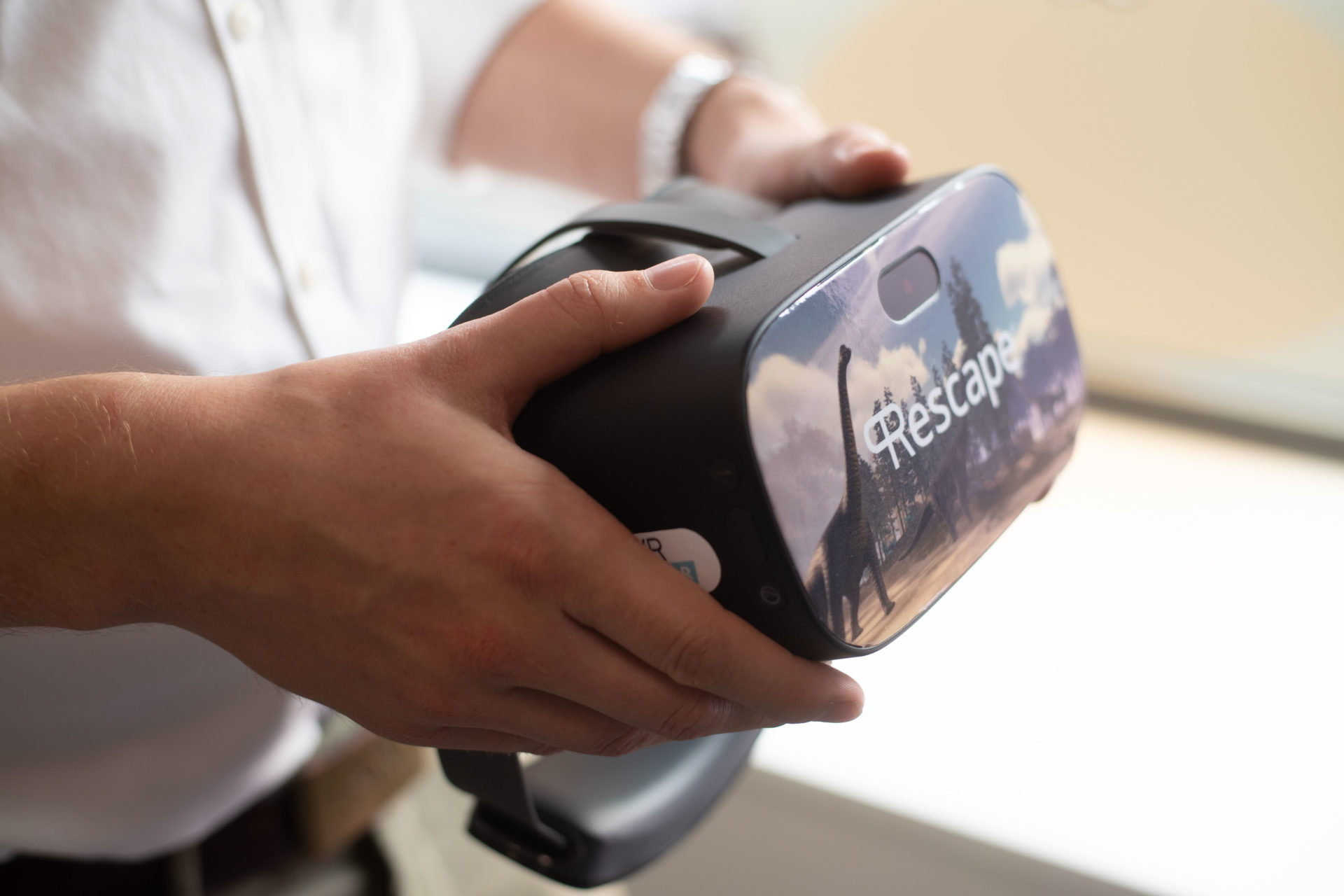 Hands holding VR headset