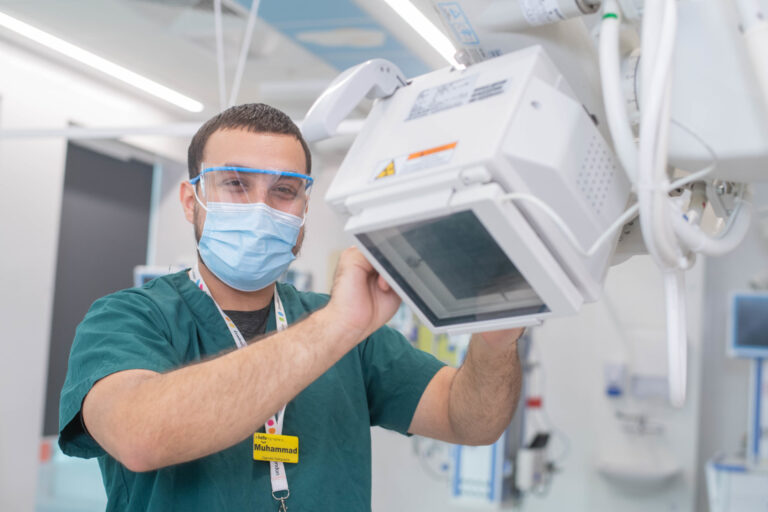 Hospital worker poses with equipment