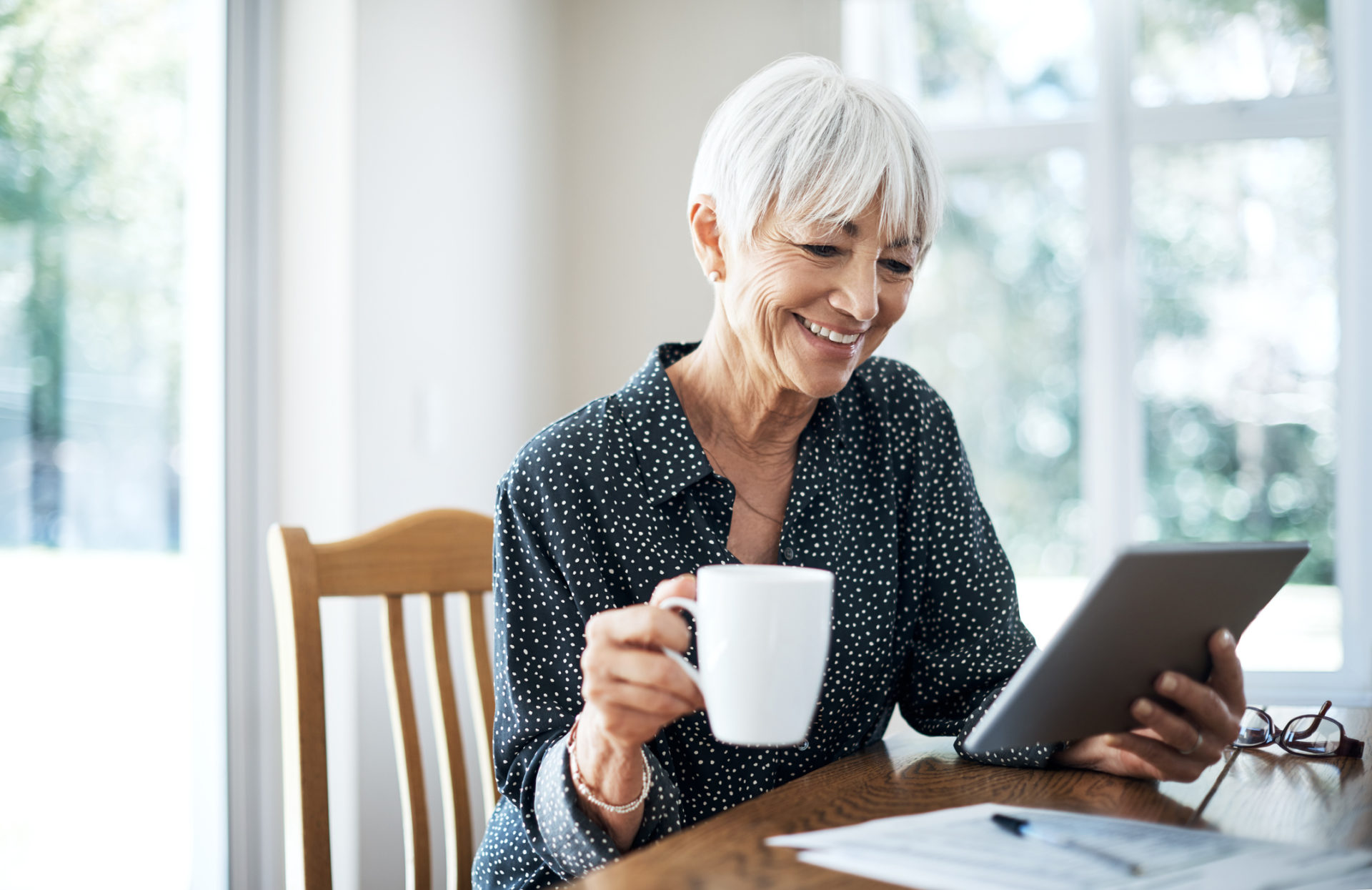 Cropped shot of a senior woman going through her finances while sitting at the dining room table