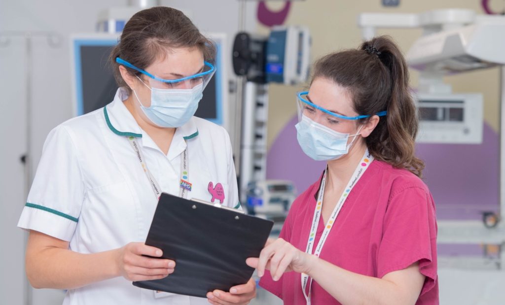 Two Evelina team looking at charts