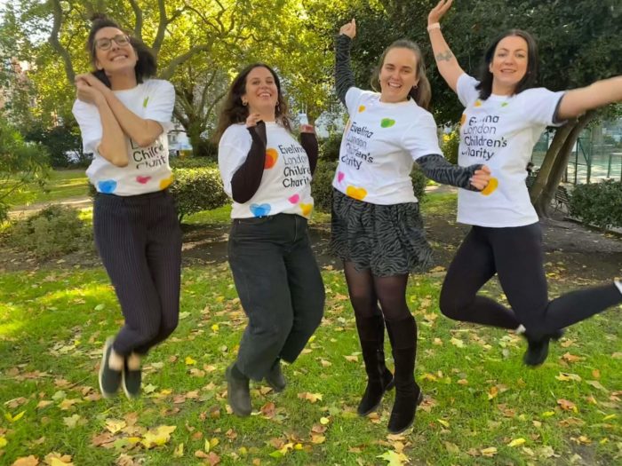 Staff in Evelina t-shirts jump in the air