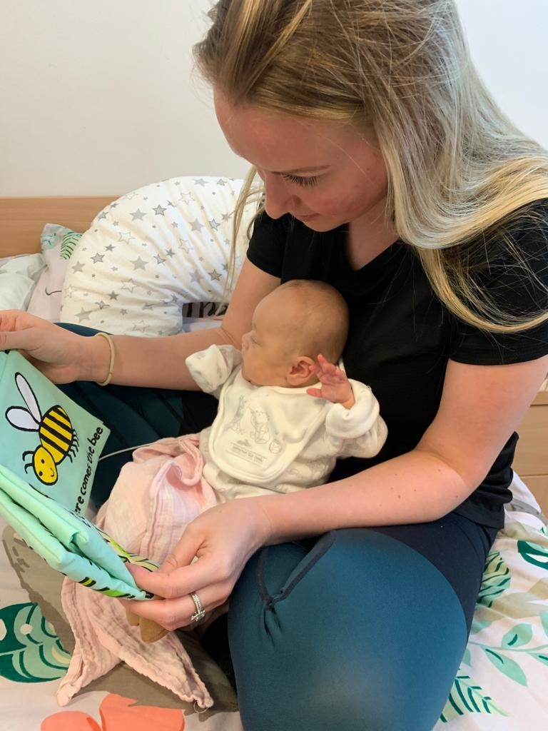 April and Baby Margot reading a book