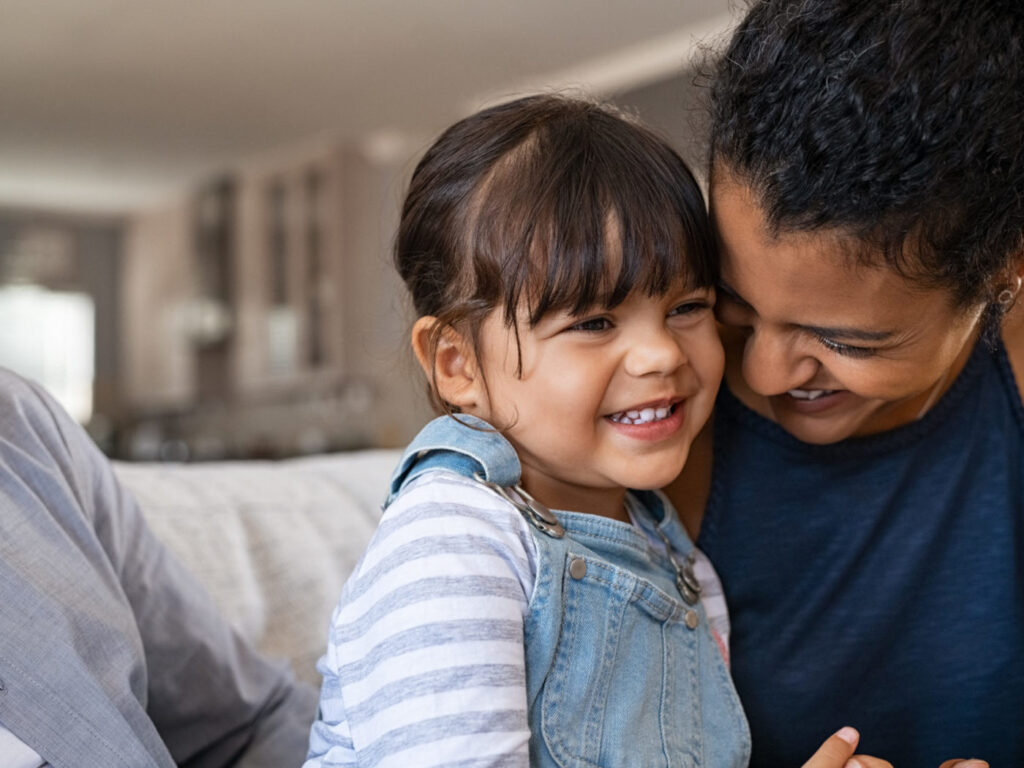 Image of a girl and adult smiling together