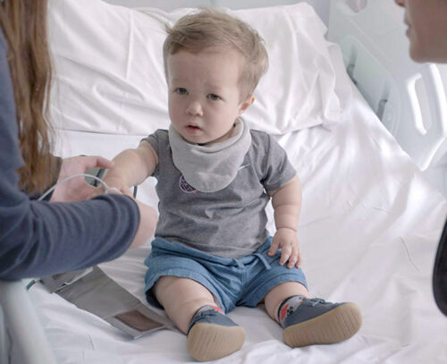 Image of a child having a check-up in a hospital bed