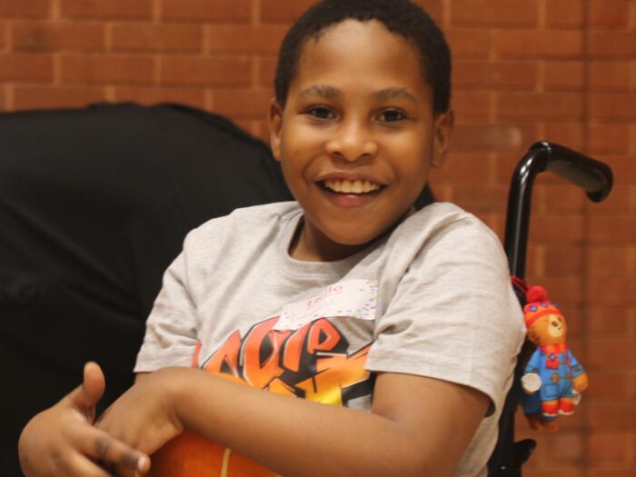 Emmanuel holding an orange basket ball.