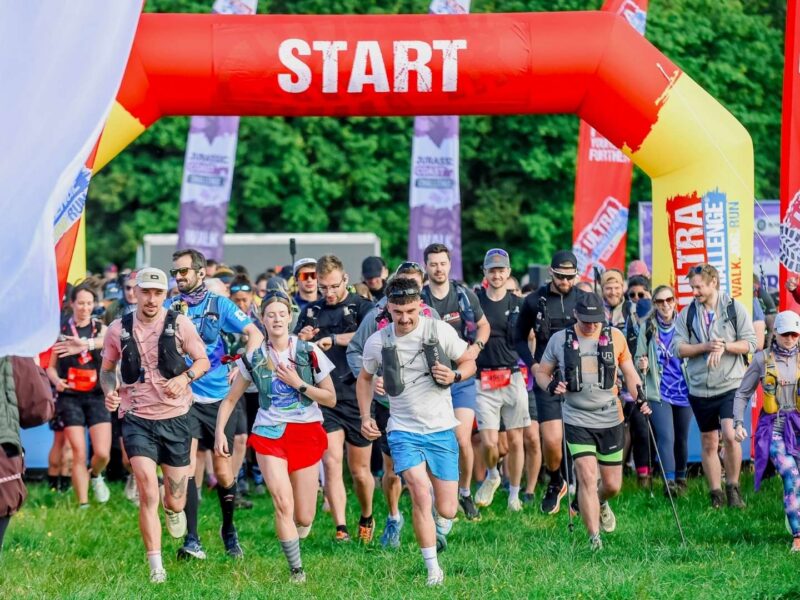 Ultra Challenge participants all at the start of the race. There's red inflatable that say's 'Start' and a range of long pull up flags.