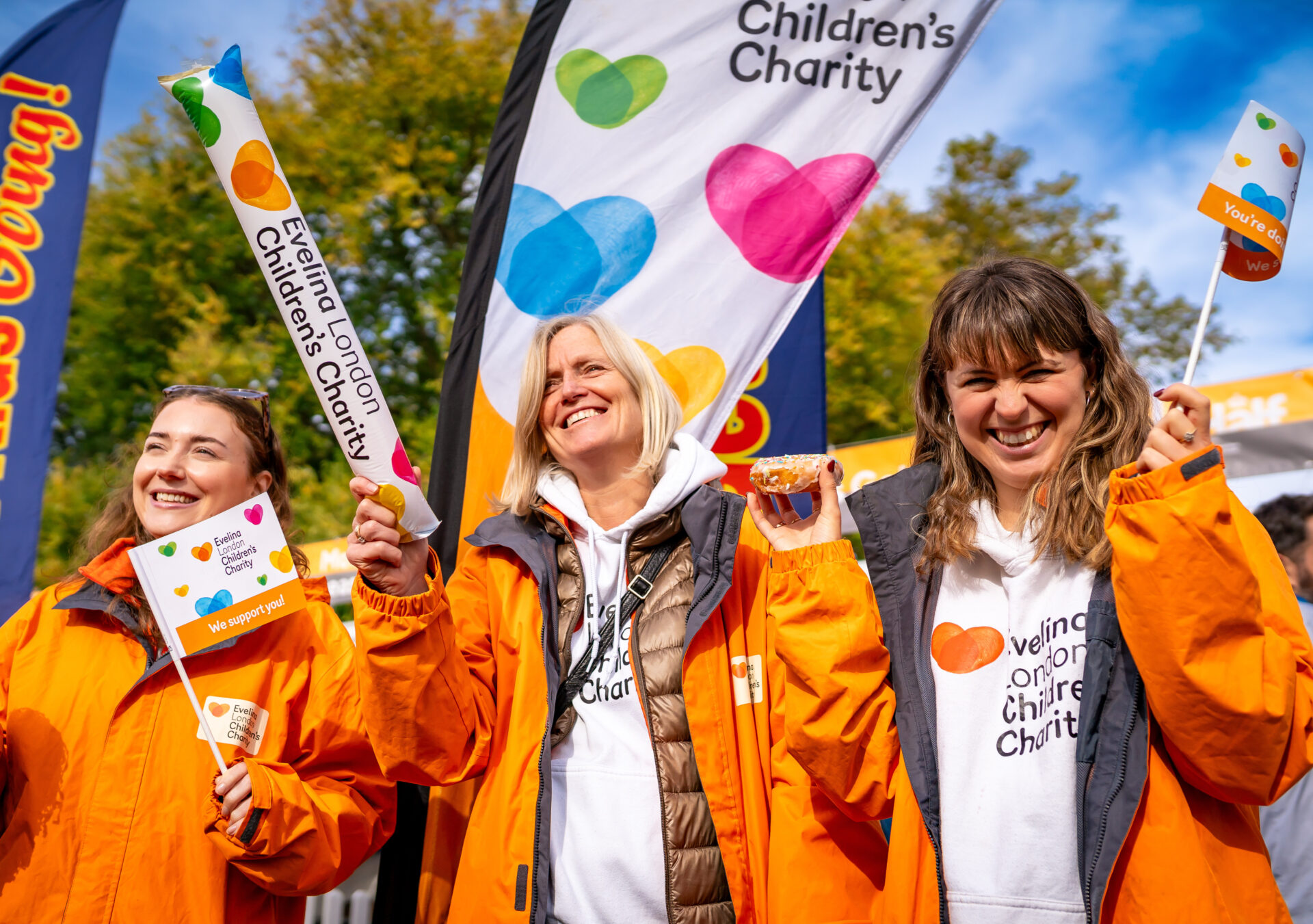 Three Evelina London Children's charity supporters cheering on fundraisers