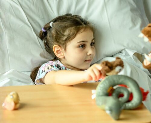 Olilia in the hospital bed at Evelina London Children