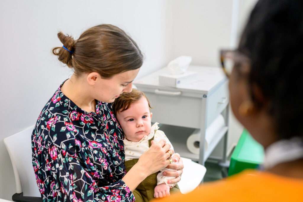 Mother holding her baby at an appointment in Evelina London Children