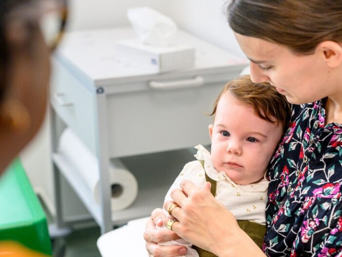 Mother holding her baby at an appointment in Evelina London Children
