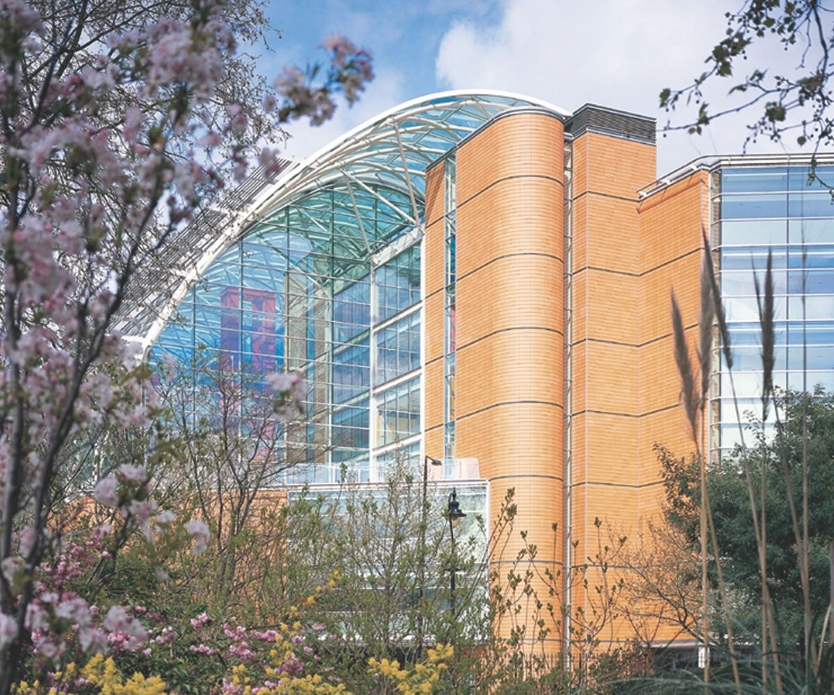 Evelina London Children's Hospital building amongst shrubbery and flowers.