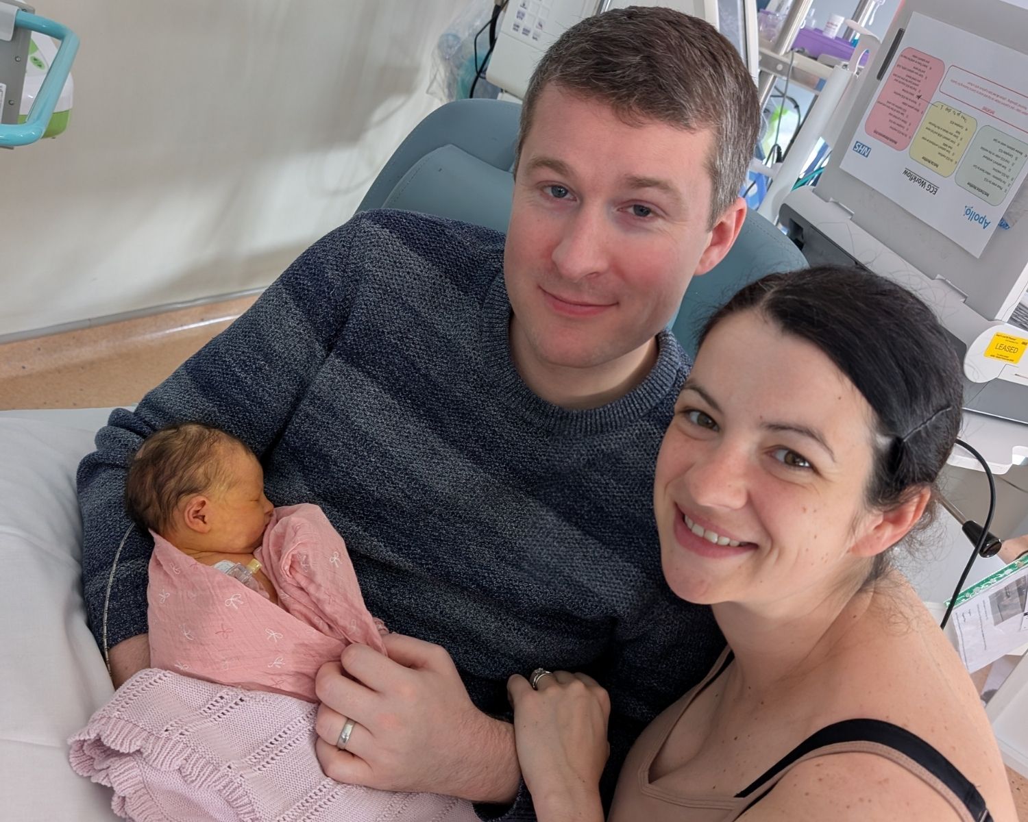 Baby Ada being held by her parents Nick and Becky at Evelina London Children's Hospital.